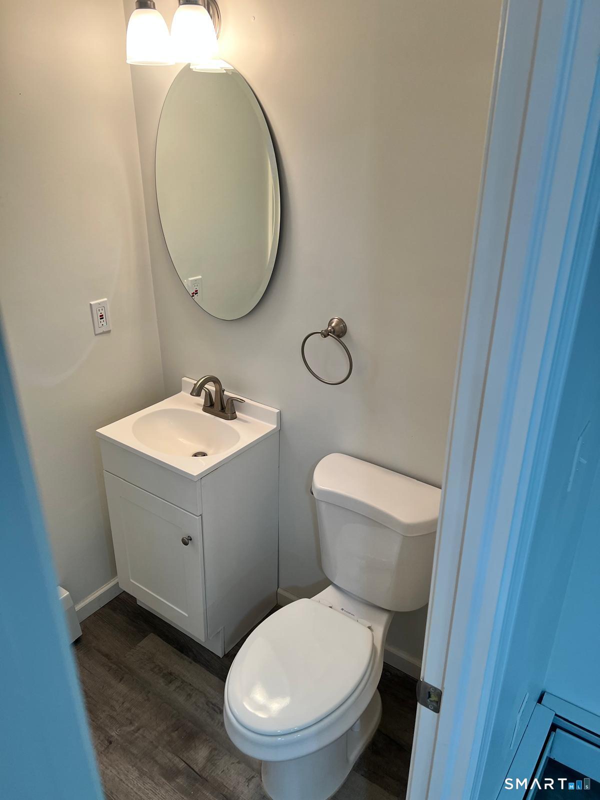 34 Norman Street Manchester, CT 06040 - Photo 6 of 19 a bathroom with a toilet sink and mirror