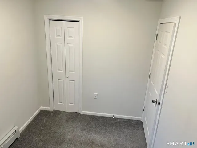 an empty room with closet area