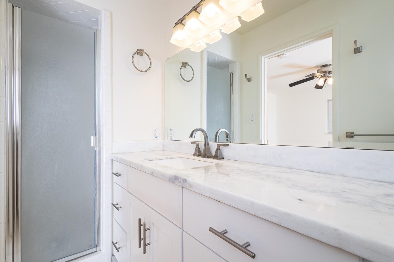 2855 La Colina Way Carmichael, CA 95608 - Photo 12 of 25 a bathroom with a granite countertop sink a mirror and vanity