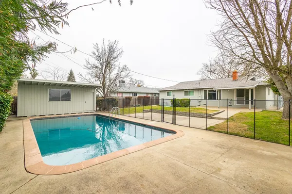 a view of a swimming pool with a patio