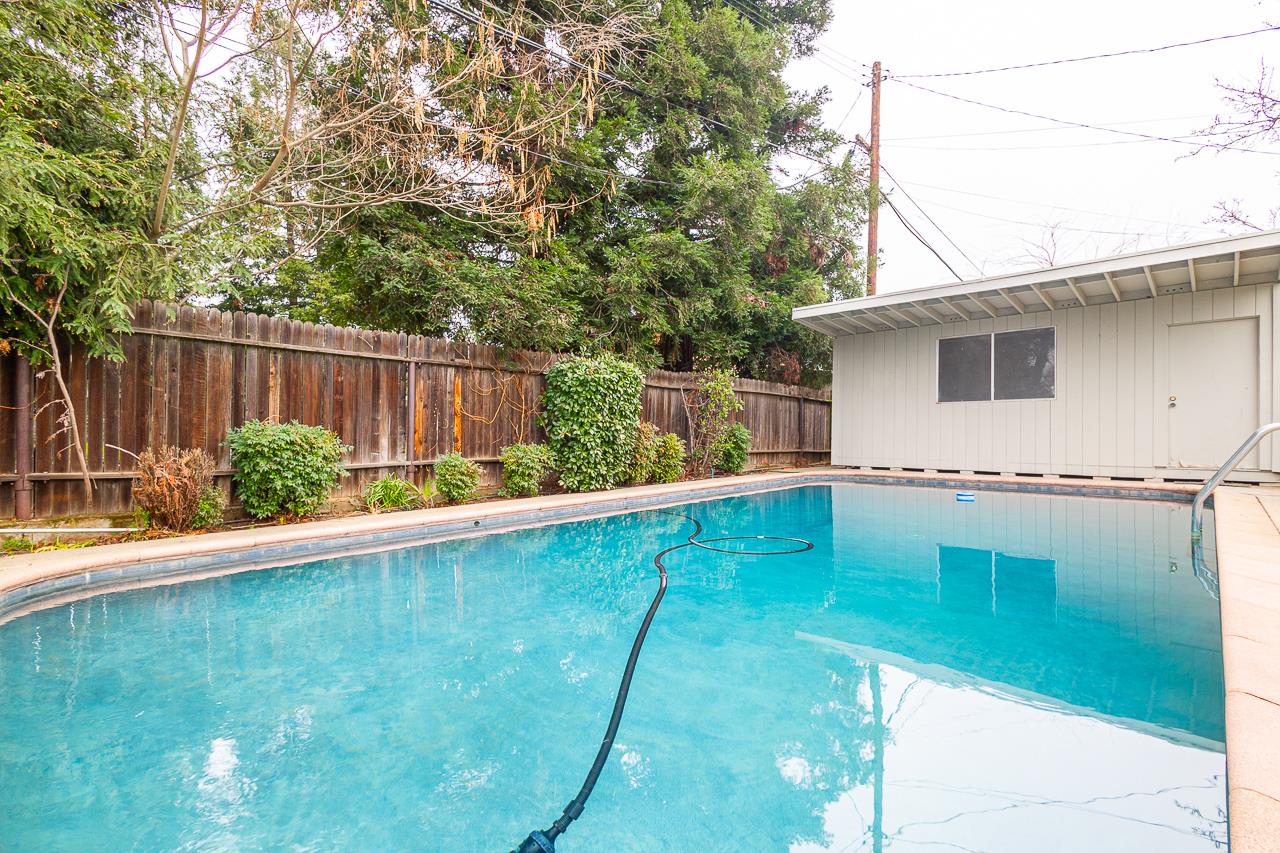 2855 La Colina Way Carmichael, CA 95608 - Photo 21 of 25 a view of backyard with potted plants and wooden fence