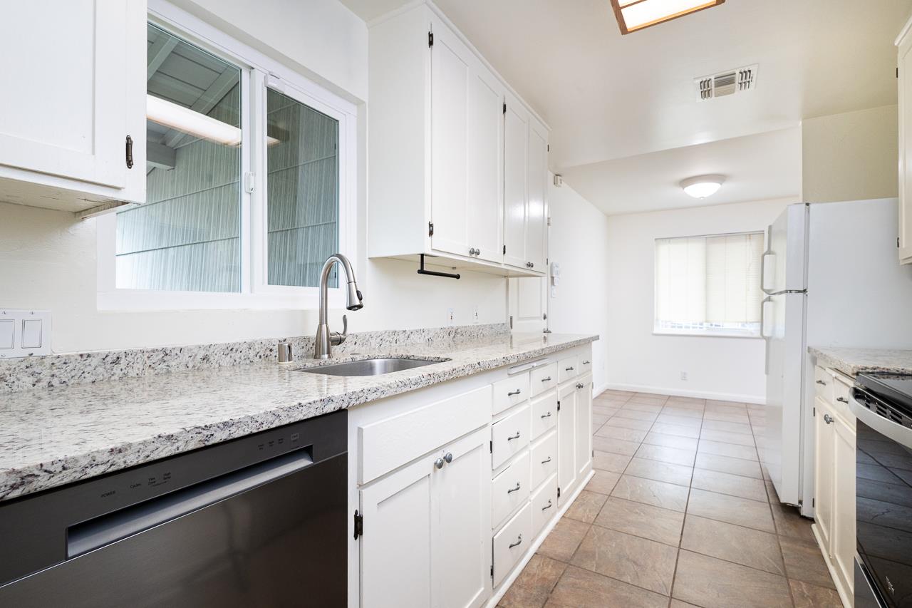 2855 La Colina Way Carmichael, CA 95608 - Photo 6 of 25 a kitchen with granite countertop a sink and cabinets