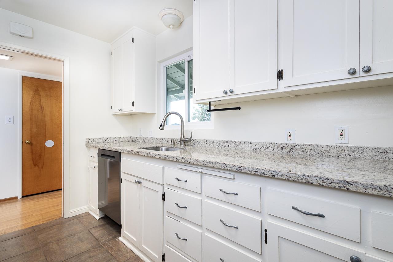2855 La Colina Way Carmichael, CA 95608 - Photo 8 of 25 a kitchen with granite countertop white cabinets and a sink