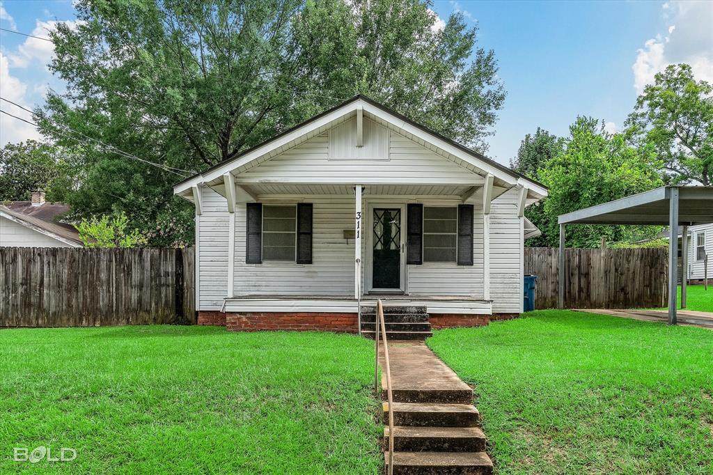a front view of house with yard and green space