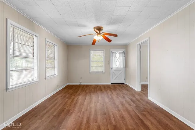 wooden floor in an empty room with a window