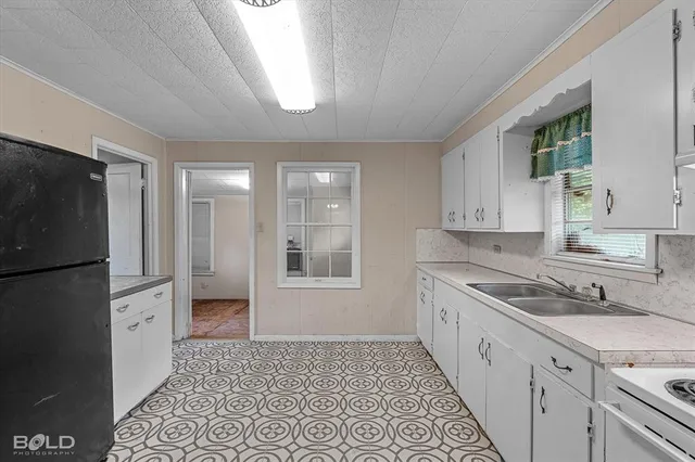 a kitchen with a sink and refrigerator