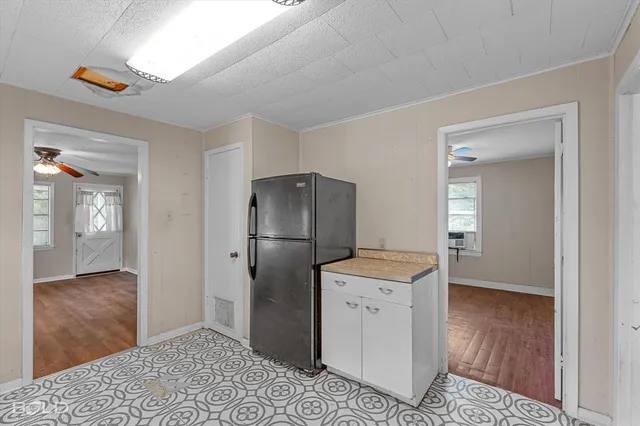 a kitchen with a refrigerator and a sink