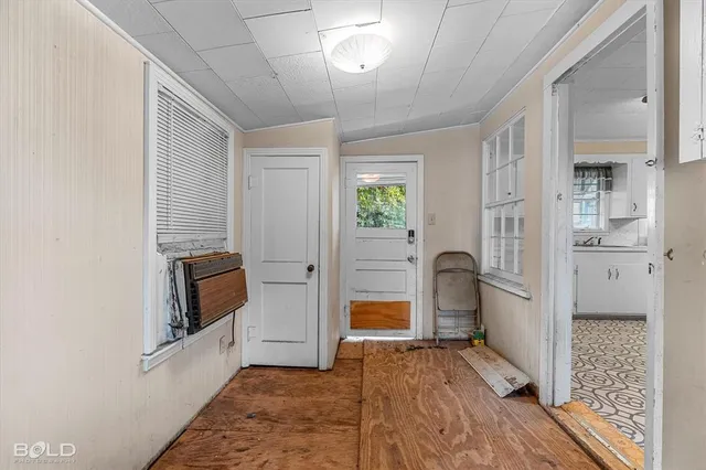 a view of kitchen with furniture and refrigerator