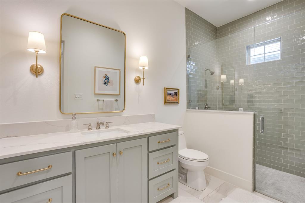 14000 Rozana Street Fort Worth, TX 76008 - Photo 23 of 38 a bathroom with a toilet sink and mirror
