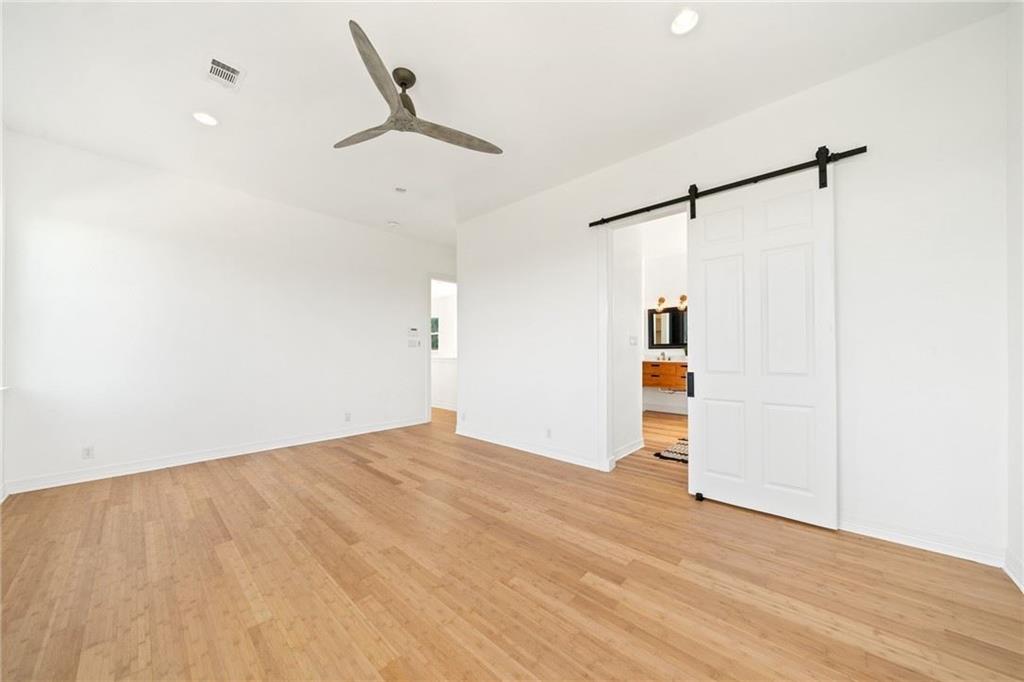 13301 Lone Rider Trail Bee Cave, TX 78738 - Photo 12 of 21 Spacious interior with hardwood floors and a modern ceiling fan