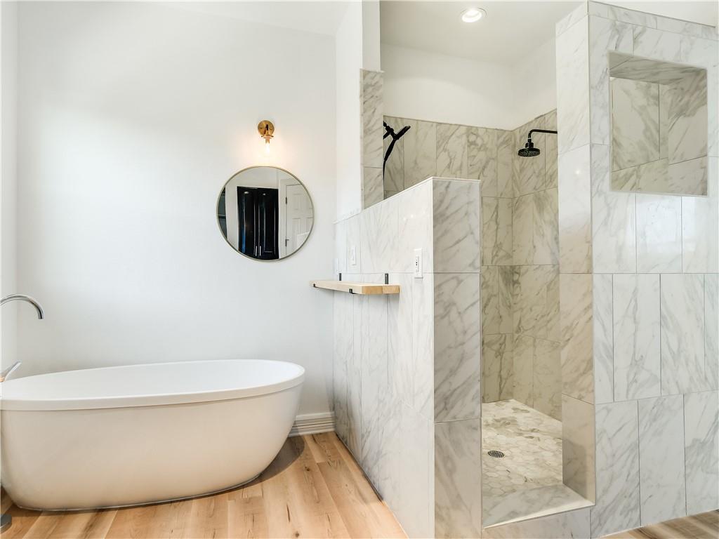 13301 Lone Rider Trail Bee Cave, TX 78738 - Photo 8 of 21 The bathroom features a freestanding soaking tub and a walk-in shower with natural stone tiling