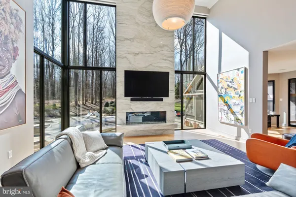 a living room with furniture and large windows