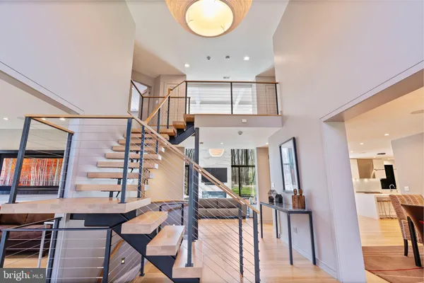 a living room with furniture a flat screen tv and a floor to ceiling window