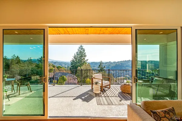 a view of a balcony with a forest