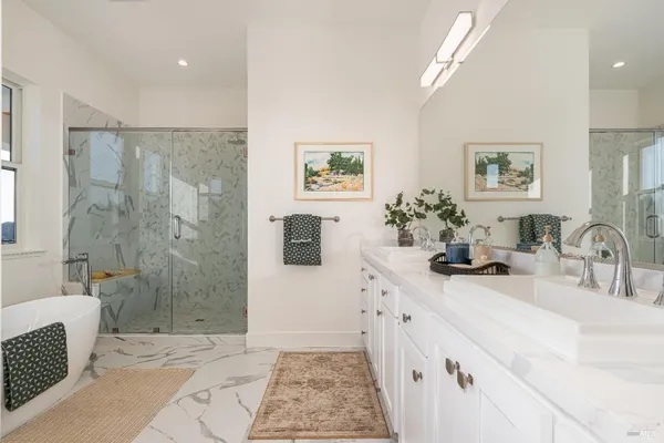 a bathroom with a granite countertop sink mirror vanity and toilet