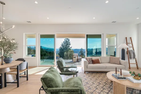 a living room with fireplace furniture and a large window