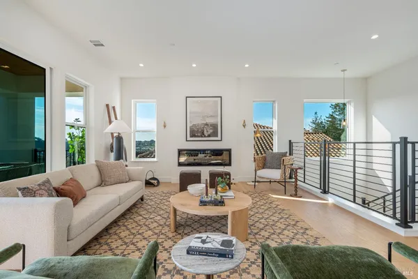 a living room with furniture and a view of kitchen