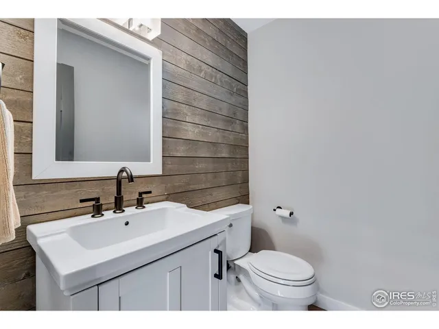 a bathroom with a sink toilet and mirror