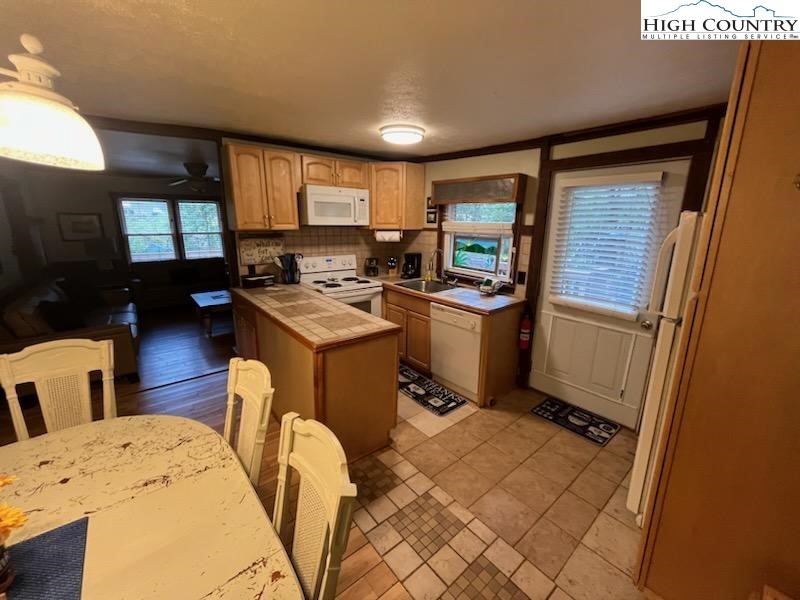392 Old Danner Road Vilas, NC 28692 - Photo 11 of 34 a kitchen with stainless steel appliances granite countertop a sink stove and refrigerator