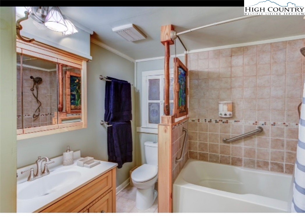 392 Old Danner Road Vilas, NC 28692 - Photo 16 of 34 a bathroom with a bathtub shower sink vanity and toilet