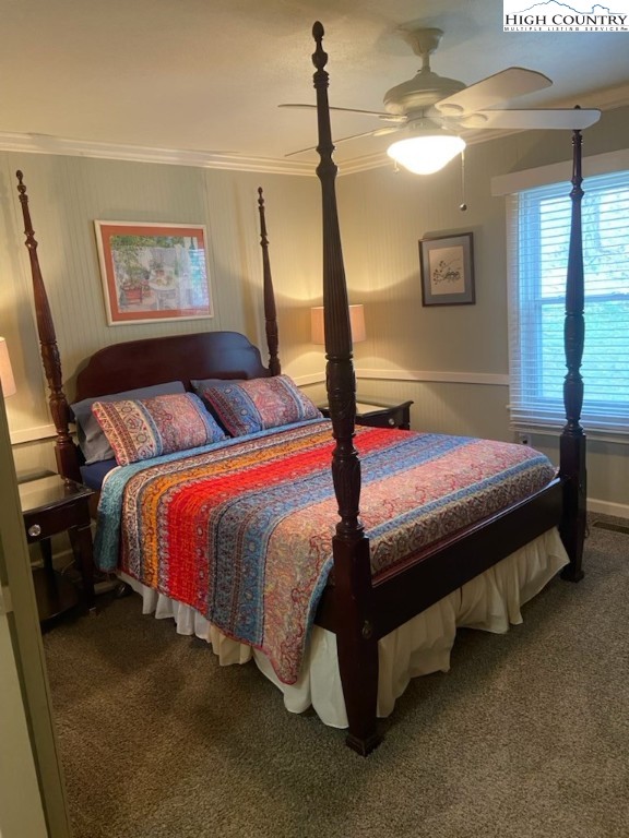 392 Old Danner Road Vilas, NC 28692 - Photo 19 of 34 a bedroom with a bed lamp and a chandelier