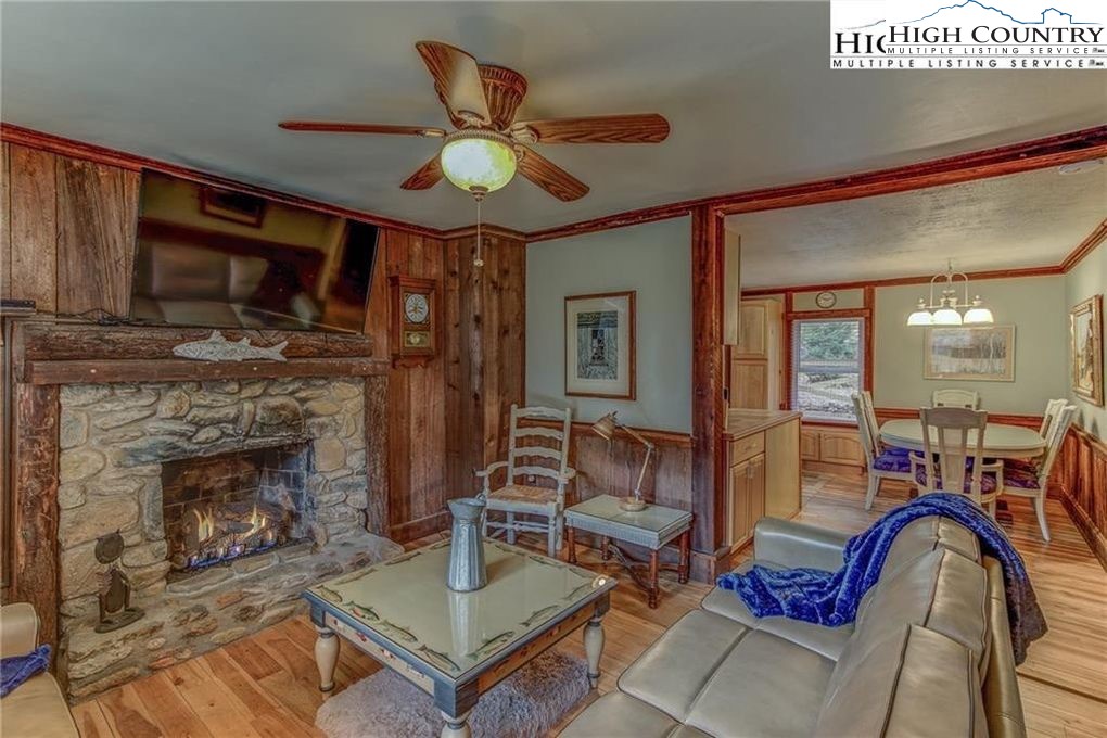 392 Old Danner Road Vilas, NC 28692 - Photo 4 of 34 a living room with furniture a flat screen tv and a fireplace
