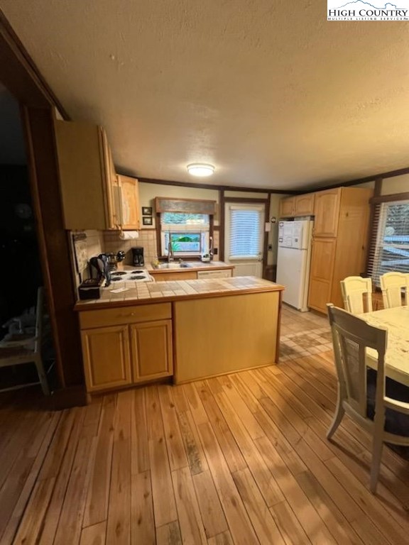 392 Old Danner Road Vilas, NC 28692 - Photo 9 of 34 a kitchen with wooden floors and wooden cabinets