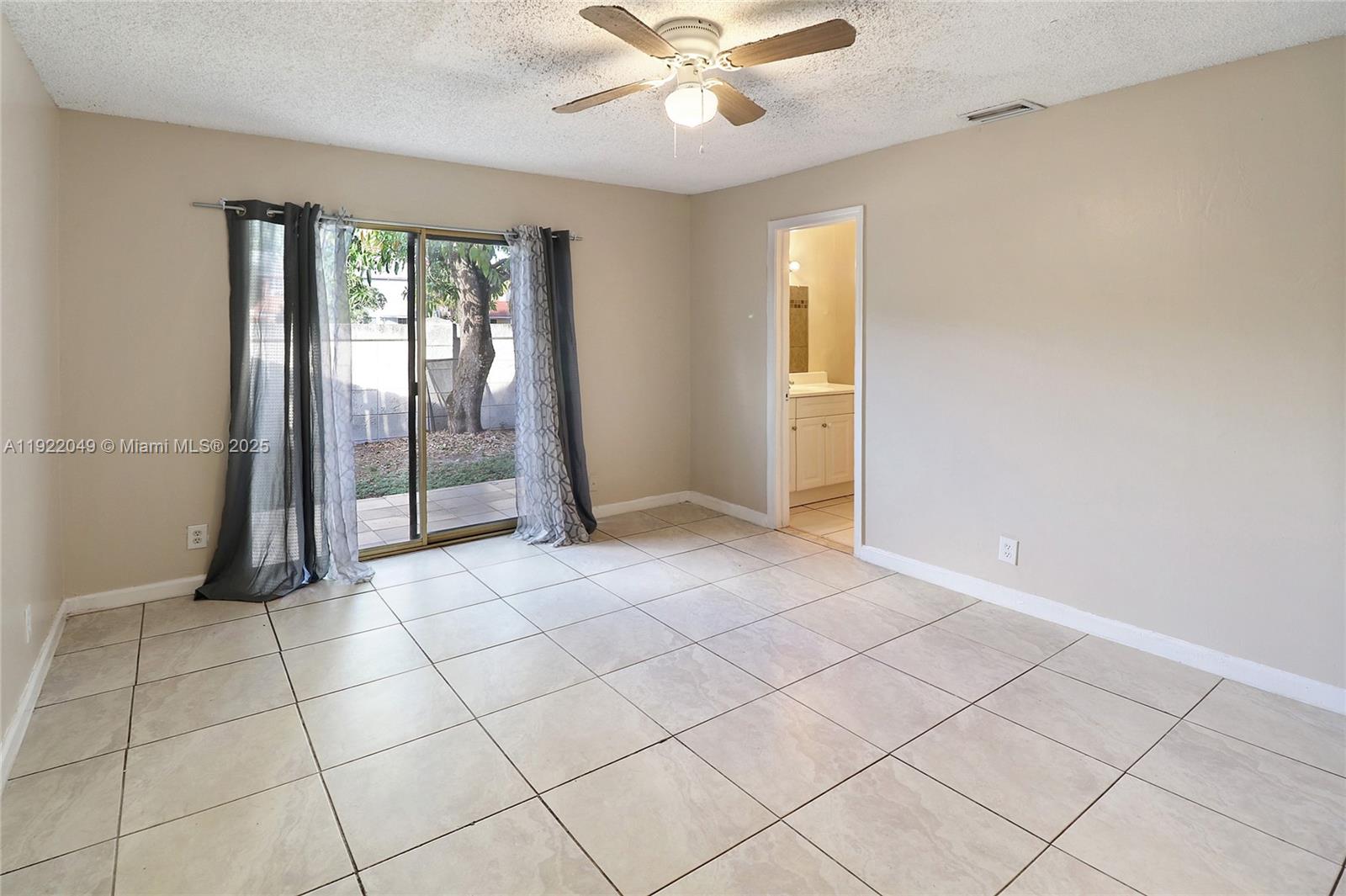 6533 Harbour Road North Lauderdale, FL 33068 - Photo 12 of 20 a view of an empty room with a chandelier fan