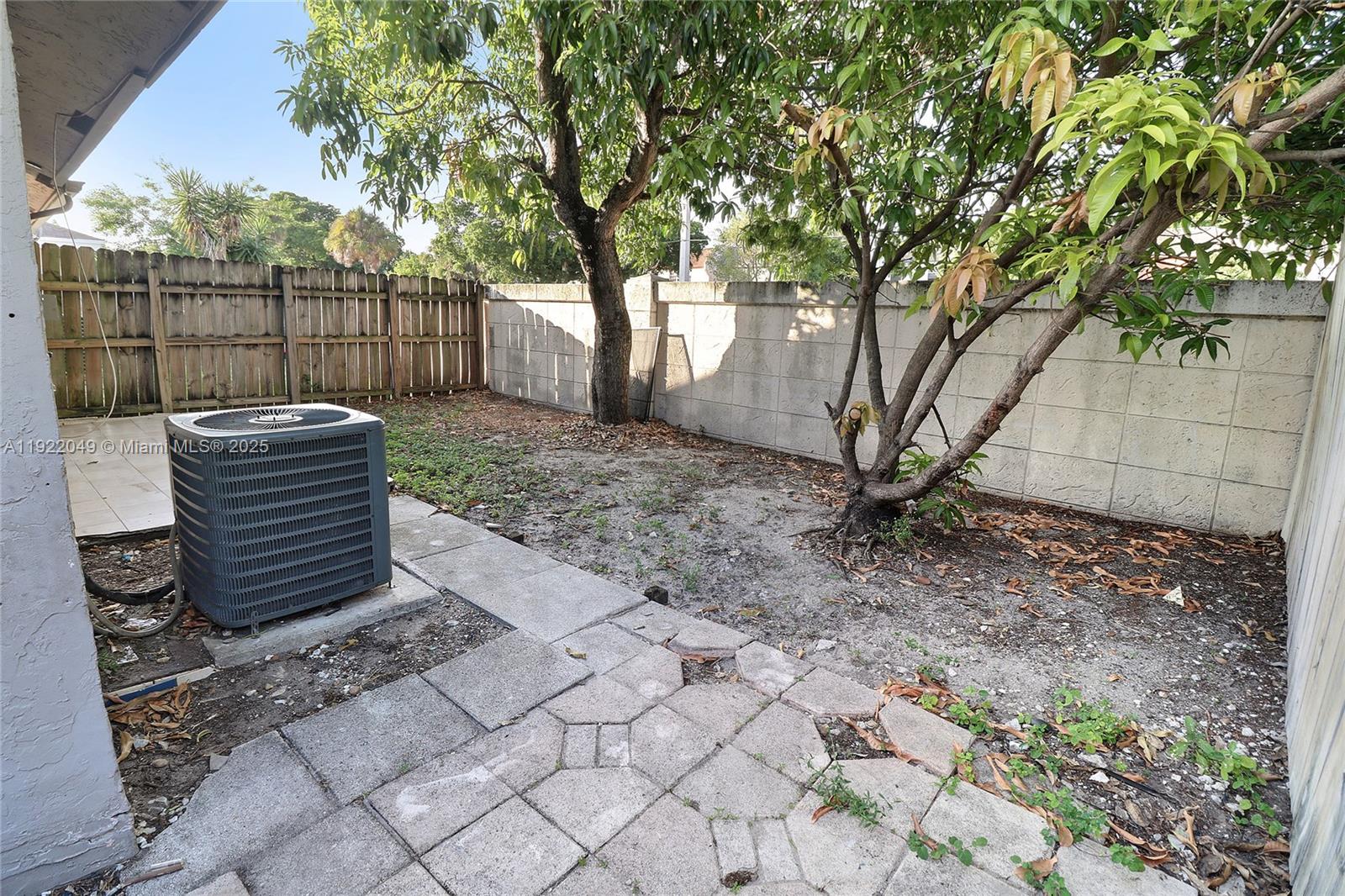 6533 Harbour Road North Lauderdale, FL 33068 - Photo 20 of 20 a view of backyard with wooden fence and large trees