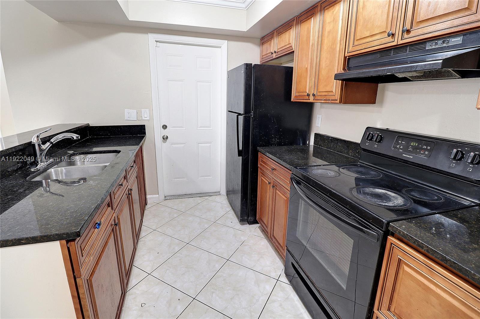 6533 Harbour Road North Lauderdale, FL 33068 - Photo 4 of 20 a kitchen with a stove and a refrigerator