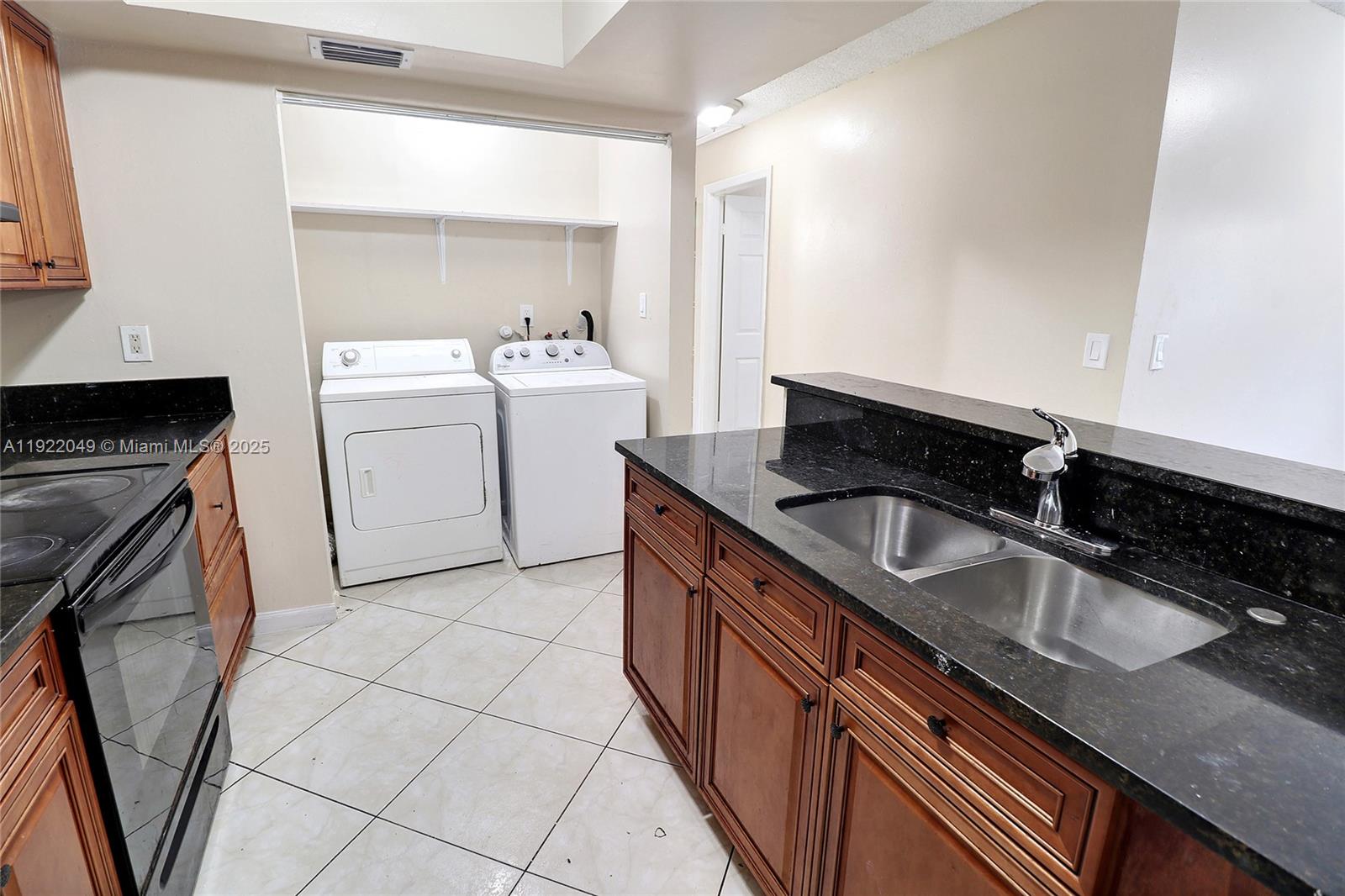 6533 Harbour Road North Lauderdale, FL 33068 - Photo 5 of 20 a utility room with sink a washer and dryer