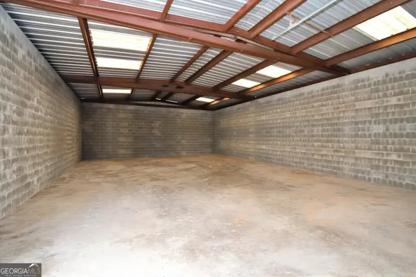 a kitchen with a sink a stove and white cabinets