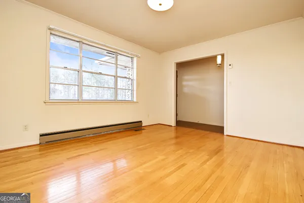 a view of a bathroom with a door and a wooden floor