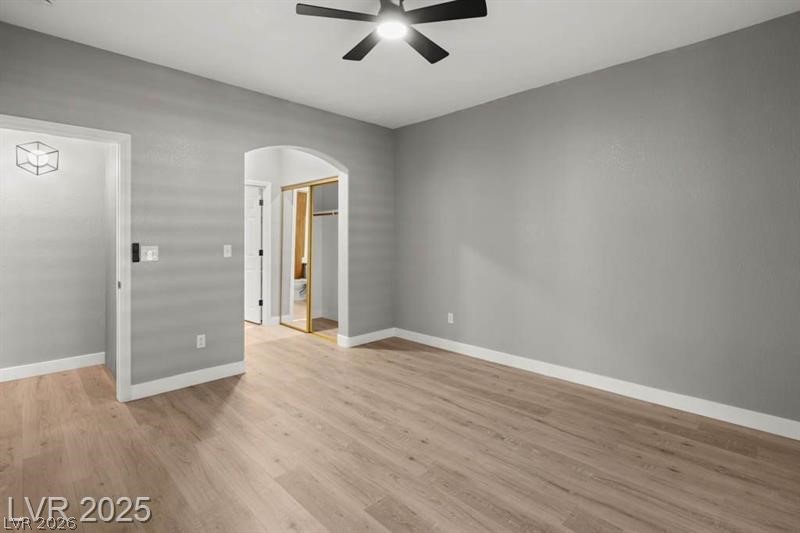 3320 South Fort Apache Road, Unit 125 Las Vegas, NV 89117 - Photo 12 of 26 An airy bedroom with wood-look flooring and a modern ceiling fan, offering a tranquil retreat.