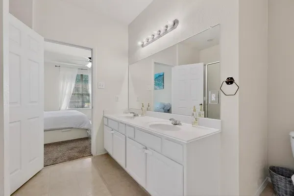 a en suite bathroom with a double vanity sink mirror and double