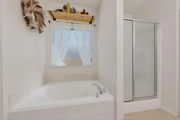 a white bath tub sitting next to a shower