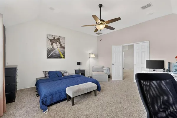 a bedroom with a bed and a chandelier