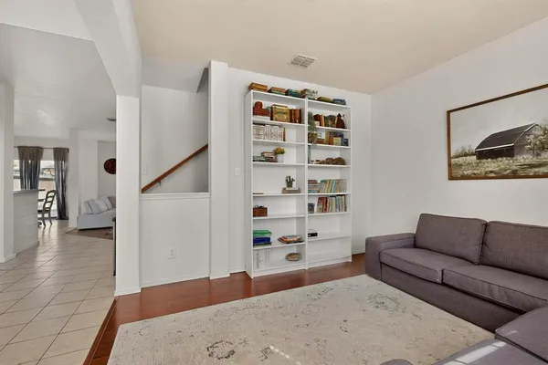 a living room with furniture and wooden floor