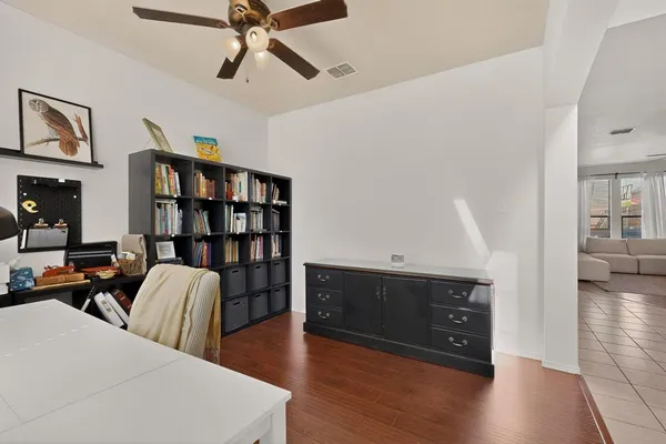 a living room with furniture and a book shelf