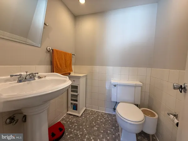 a bathroom with a sink toilet and a mirror