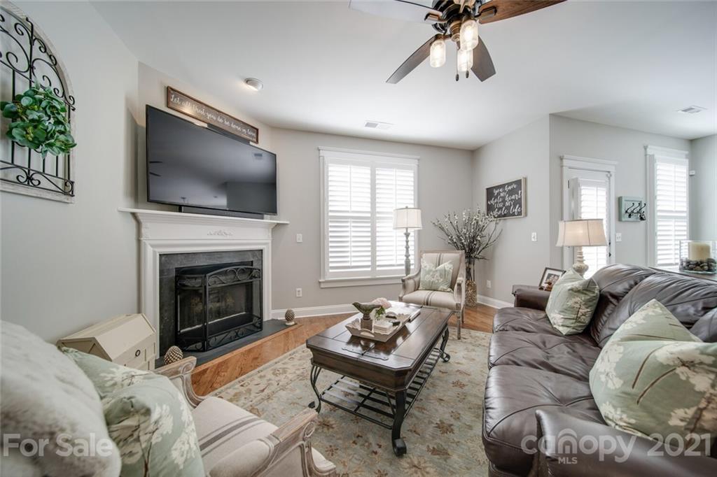 2513 Lower Assembly Drive Fort Mill, SC 29708 - Photo 23 of 47 a living room with furniture a flat screen tv and a fireplace