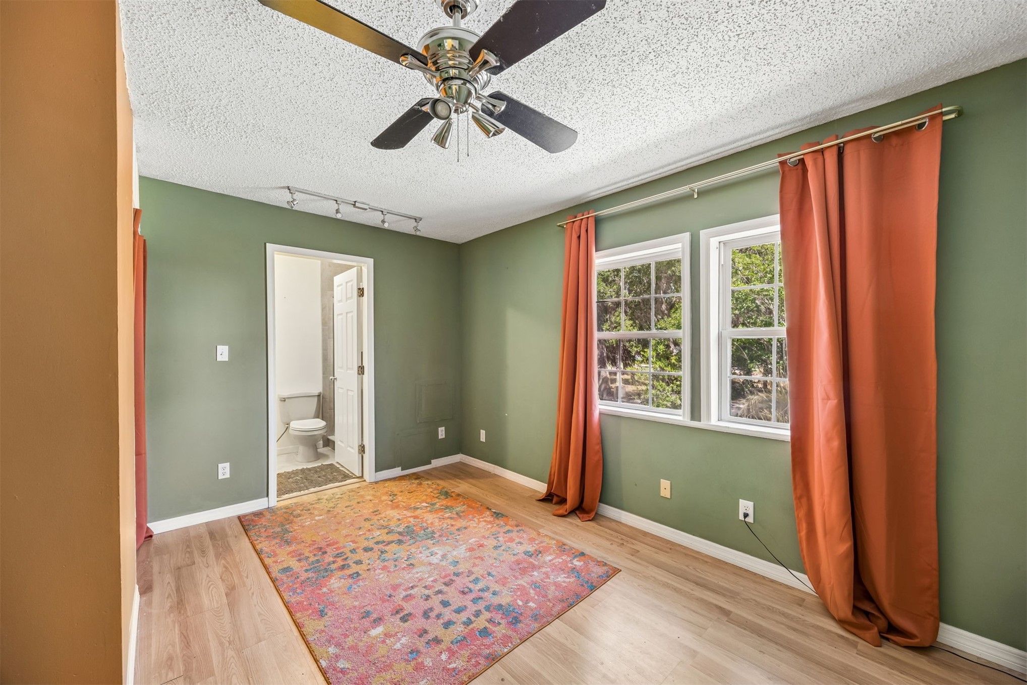 85013 Avant Road Yulee, FL 32097 - Photo 16 of 46 a view of a room with a ceiling fan and wooden floor