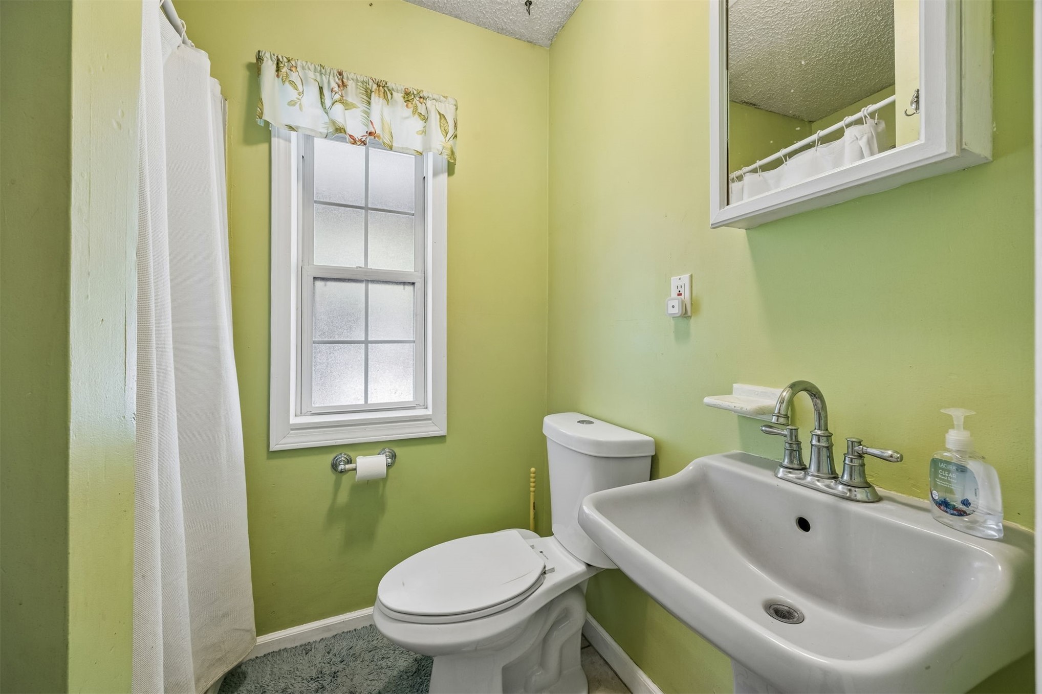 85013 Avant Road Yulee, FL 32097 - Photo 18 of 46 a bathroom with a sink mirror and toilet