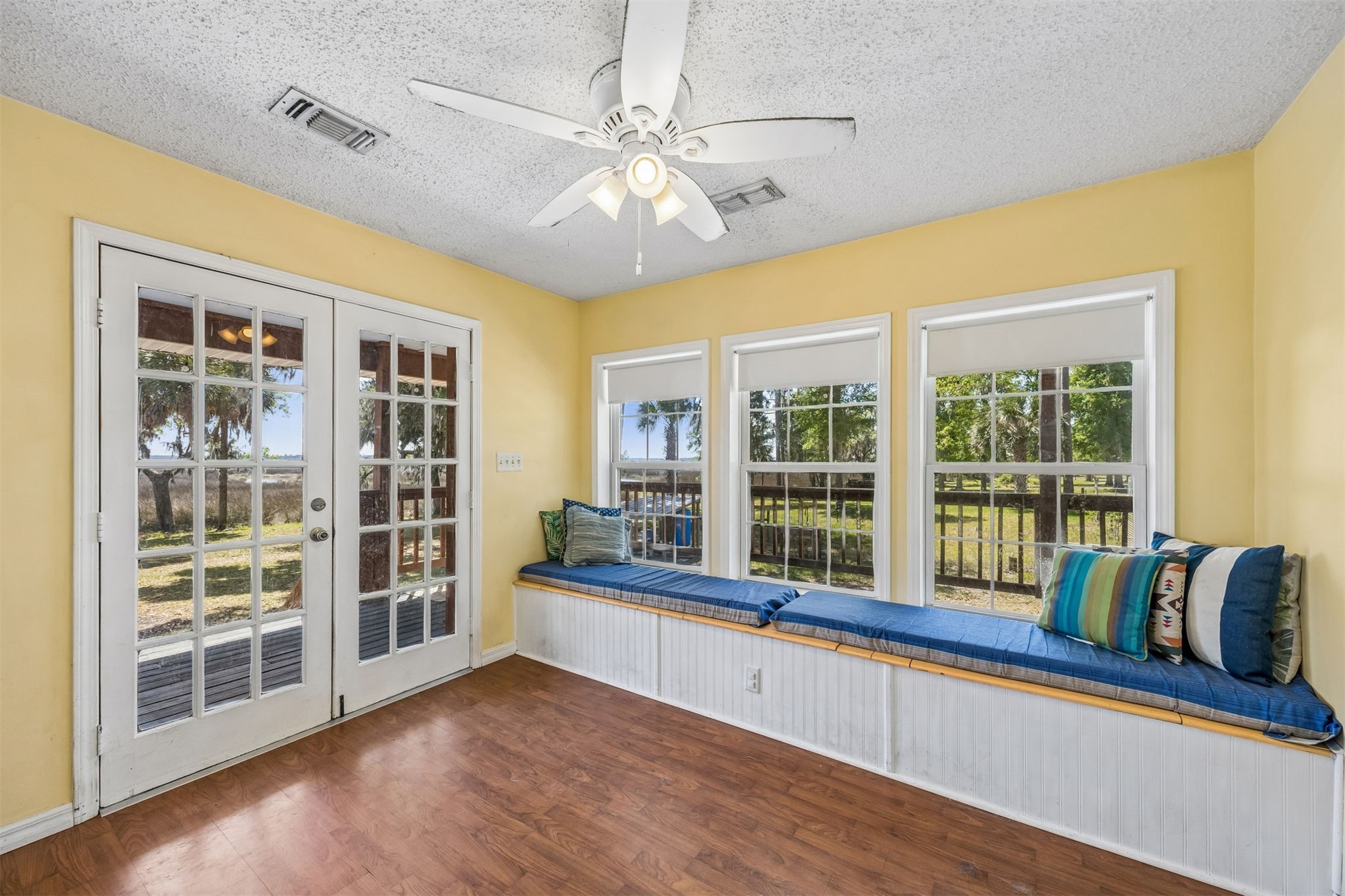 85013 Avant Road Yulee, FL 32097 - Photo 5 of 46 a view of a kitchen with a large window and wooden floor