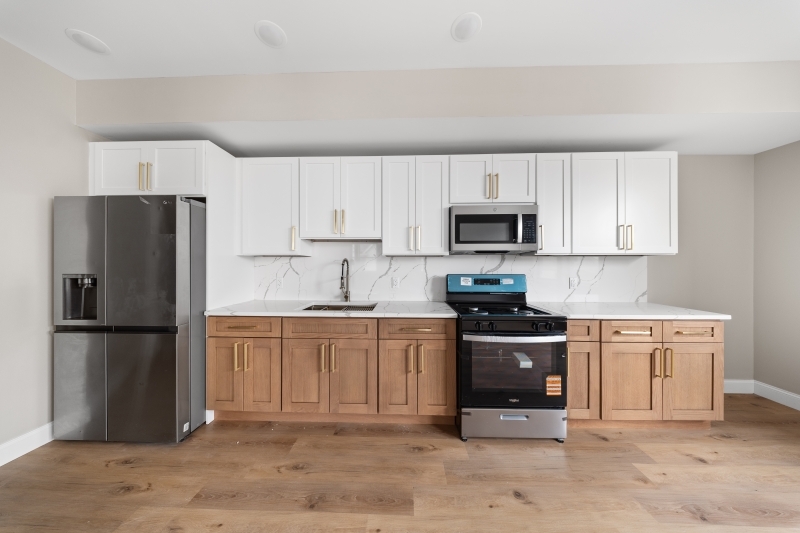 a kitchen with stainless steel appliances granite countertop a refrigerator stove and microwave