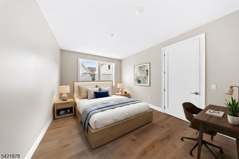 17 Wickham Street, Unit 203 Passaic, NJ 07055 - Photo 13 of 15 a bedroom with a bed and a desk