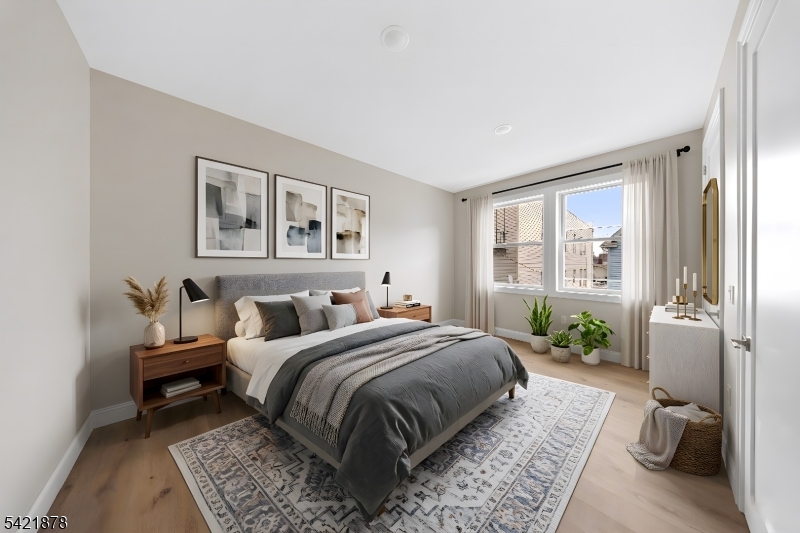 17 Wickham Street, Unit 203 Passaic, NJ 07055 - Photo 14 of 15 a bed room with a bed and a couch