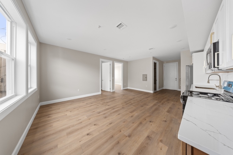 17 Wickham Street, Unit 203 Passaic, NJ 07055 - Photo 2 of 15 a view of a kitchen with a sink dishwasher and wooden floor