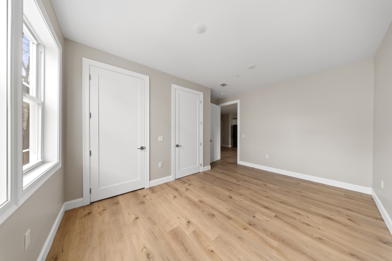 17 Wickham Street, Unit 203 Passaic, NJ 07055 - Photo 7 of 15 a view of an empty room with wooden floor