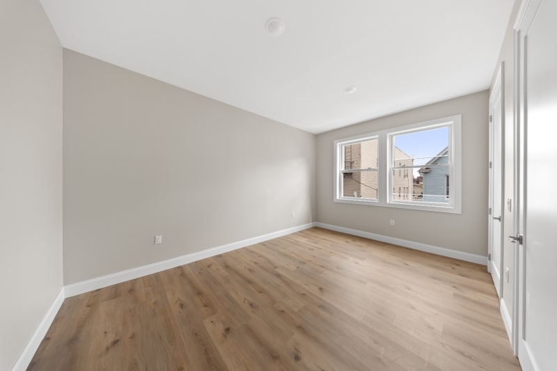 17 Wickham Street, Unit 203 Passaic, NJ 07055 - Photo 8 of 15 wooden floor in an empty room with a window